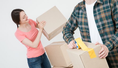 Driver and helper transporting boxes and furniture near Fulham Broadway