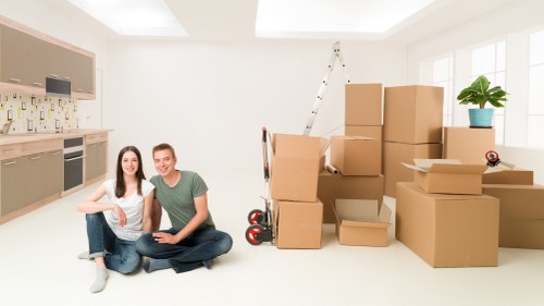 Professional movers loading household items from a Fulham flat