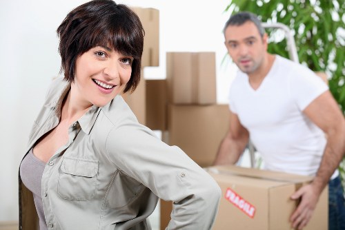 Moving a sofa and household items through a Fulham building entrance